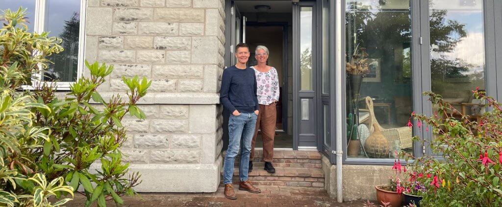 couple outside of 1930s glasgow home who have saved on their energy bills with loco home