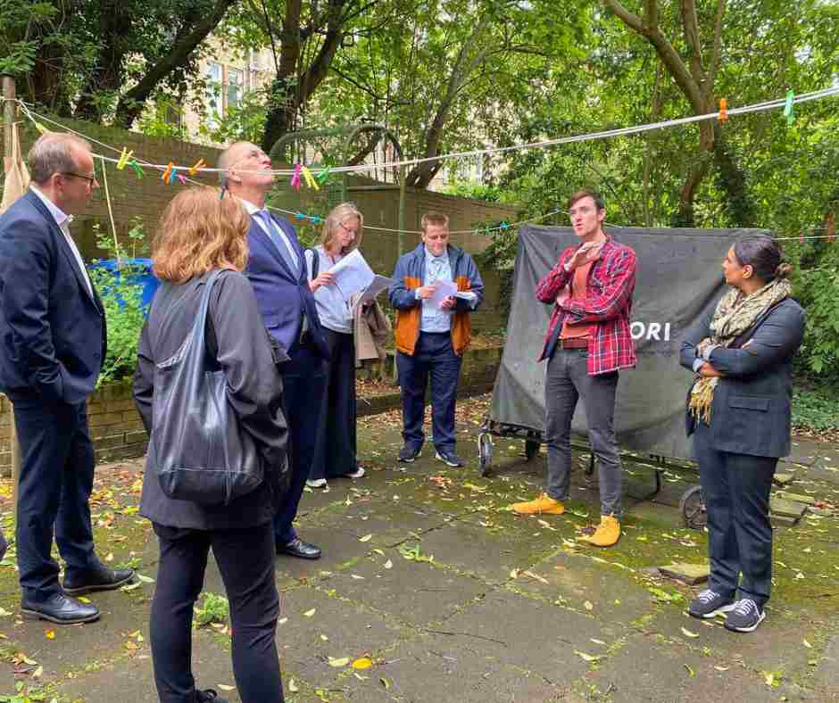 Ofgem Board visits Glasgow for Loco Home presentation and retrofit tours, board are in the back garden listening to how a one owner retrofitted his tenement