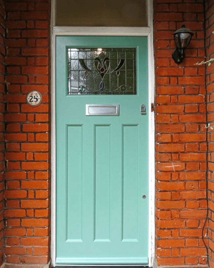 couple outside of 1930s glasgow home who have saved on their energy bills with loco home