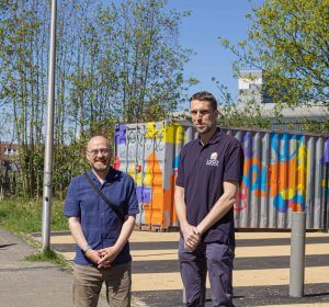 Patrick Harvie with Chris Carus of Loco Home Retrofit in Cowcaddens, Glasgow on a sunny day